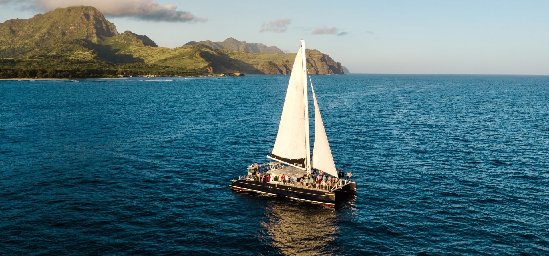 Aerial view of a boat cruising along the coast.