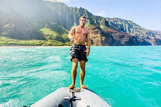 Man jumping off zodiac raft Kauai.